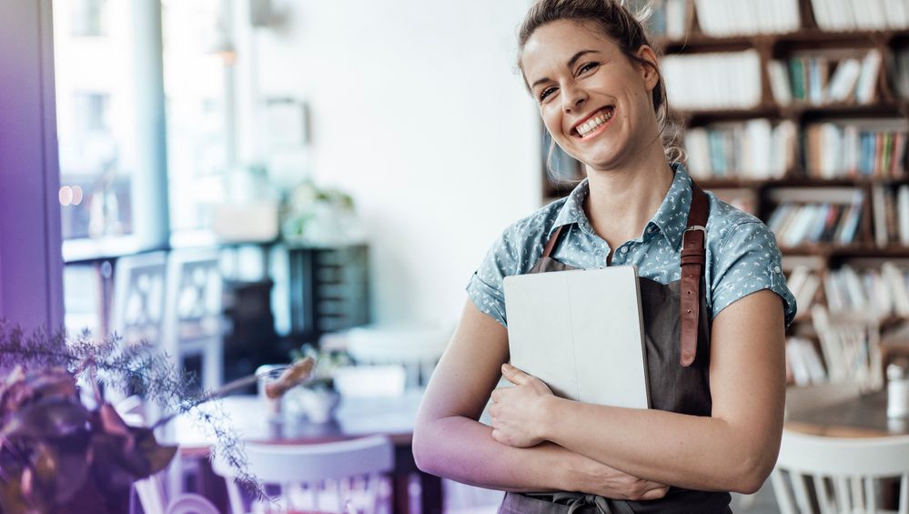 cheerful-mid-adult-waitress-holding-digital-tablet-at-cafe-1319658317-hero[1].jpg
