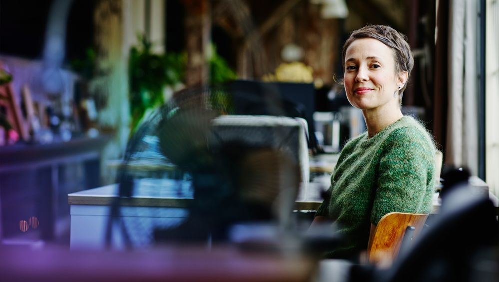 smiling-businesswoman-sitting-at-workstation-530281129-hero[1].jpg