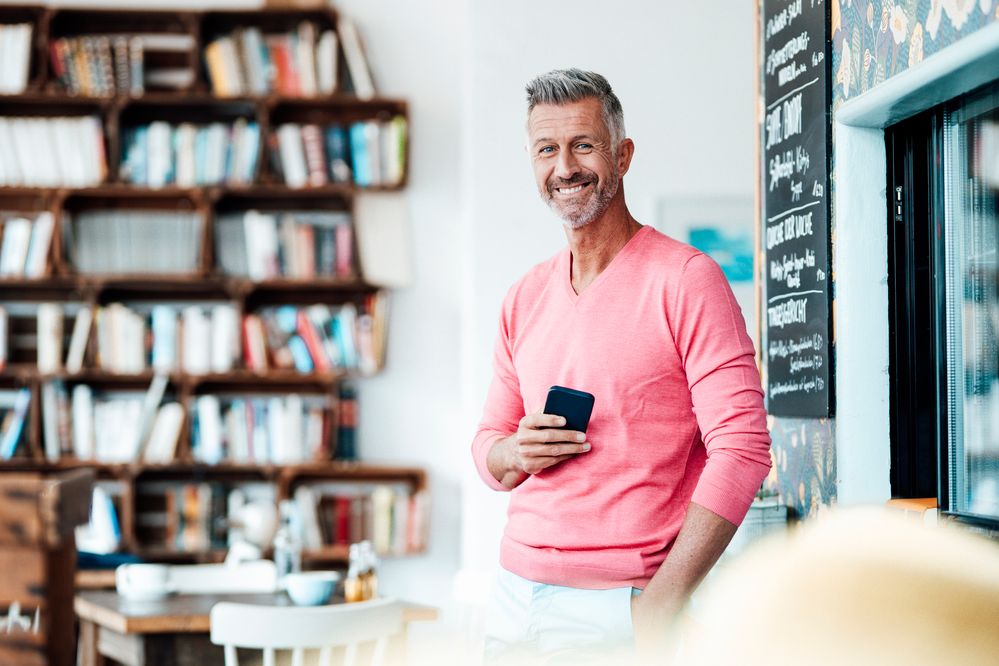 mature-male-entrepreneur-holding-smart-phone-1326120551[1].jpg